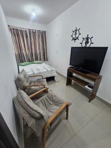 Una televisión o centro de entretenimiento en Aconchego