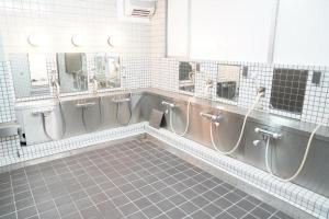 a bathroom with four urinals in a room at 心斎橋難波南Ambers hotel 3322 in Osaka +41 photos