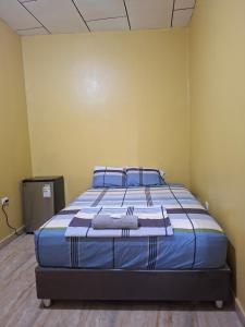 a bedroom with a large bed in a room at Santoto House in Iquitos