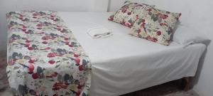 a bed with two pillows on top of it at Blackys 