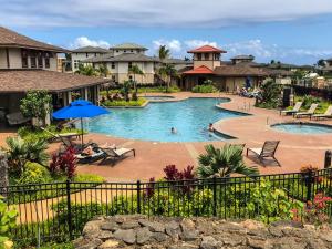 a pool at a resort with people in it at Pili Mai 15H - Central A/C in Kipu