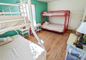 a room with two bunk beds and a table with a lamp at Jackass Hostel in North Fork