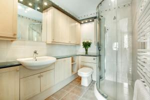 a bathroom with a sink and a toilet and a shower at Windrush in Croyde