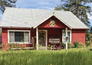 a red building with a sign on it at Jackass Hostel in North Fork