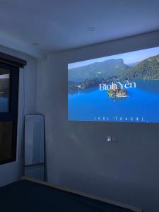 a flat screen tv on a wall in a room at Romaji House in An Khê