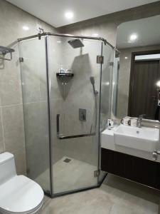 a bathroom with a shower and a toilet and a sink at Romaji House in An Khê
