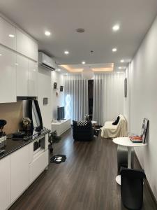 a living room with a kitchen and a living room with a table at Romaji House in An Khê