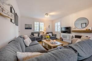 a living room with a couch and a table at Baxters Cottage in Padstow