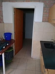 a kitchen with a door leading into a room at Depto Los Nidos 4 o 5 personas in Villa Cura Brochero +7 photos