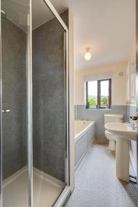 a bathroom with a shower and a toilet and a sink at Providence Mill in Hawes