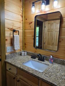 a bathroom with a sink and a mirror at Smoky's View in Sevierville +73 photos