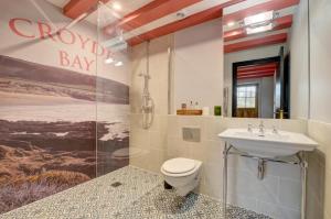 a bathroom with a toilet and a sink at Hillside The Barn in Croyde +21 photos