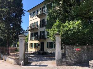 a large white building with a gate in front of it at Holiday home in Verscio with swimming pool in Verscio
