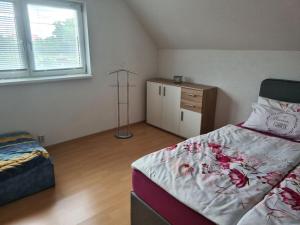a bedroom with a bed and a dresser in it at Fuhrmann Comfortable holiday residence in Neustrelitz
