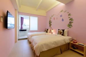 Postelja oz. postelje v sobi nastanitve Love in Hengchun B&B