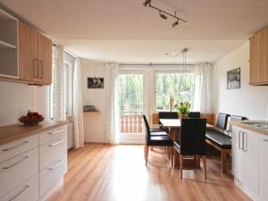 a kitchen and dining room with a table and chairs at Holiday apartment with 3 bedrooms in Enzklösterle +12 photos