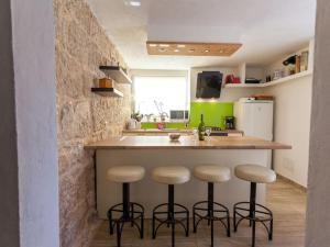 Holiday home in Gabonjin with swimming pool في Gabonjin: مطبخ مع منضدة وكراسي في جزيرة المطبخ