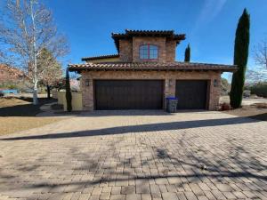 a house with a large garage in front of it at Enchanting Sedona Villa with Views Spa and Pool in Sedona