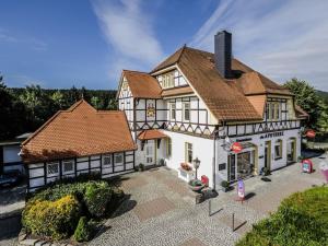 an aerial view of a large white house with at Bergwaldchalet Wellness 7 in Schierke