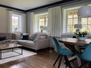 a living room with a couch and a table at Schroeder's House Kampen House 2 in Kampen