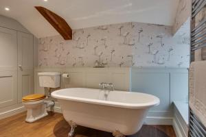 Un baño con bañera y WC. en Memories Cottage, en Milnthorpe 18 fotos más