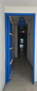 a hallway with blue doors and a hallway with stairs at La Contessa in Cartagena de Indias