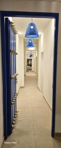 a hallway with blue chandeliers and a long corridor at La Contessa in Cartagena de Indias