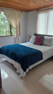 a large bed in a bedroom with a window at Alojamiento natural rural LOS NOGALES in San Francisco +35 photos