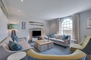 a living room with a couch and a tv at Marine Villa in Padstow