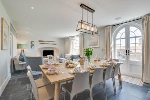 a dining room and living room with a table and chairs at Marine Villa in Padstow