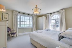 a bedroom with a large bed and a large window at Marine Villa in Padstow