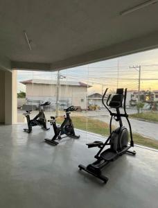 a group of four exercise bikes in a room with a large window at Slai Staycation Near Mactan Newtown in Lapu Lapu City