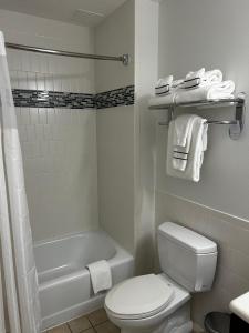 a bathroom with a toilet and a tub and a sink at Premium 2BR at Melia Celebration Close to Magic Kingdom in Orlando
