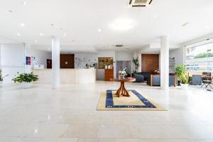 a lobby with a table in the middle of a room at Hotel La Fontaine in Esmoriz +118 photos