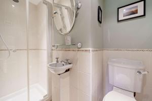 a bathroom with a toilet and a sink and a shower at High Green Cottage in Low Eskcleth +27 photos