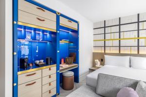 a bedroom with a bed and a blue wall at Hotel Indigo Melbourne Little Collins in Melbourne +71 photos