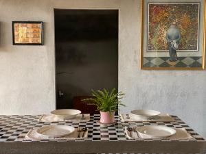 a table with three plates on a checkered table cloth at PHẠM Homestay Ca Mau in Thới Bình +22 photos