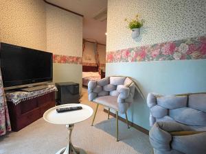 a living room with two chairs and a flat screen tv at Pension Balmy in Nasu +109 photos