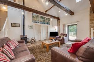 a living room with a couch and a table at Apple Barn in Fylingdales
