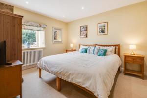 a bedroom with a large bed and a television at Apple Barn in Fylingdales