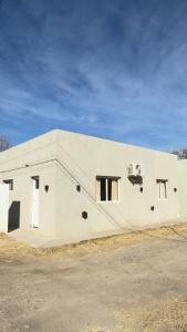 a white building with windows on the side of it at Sol Campestre in La Adela
