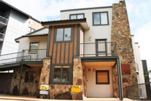 a large house with a balcony on a street at Valley View 203 AMS Mt Buller in Mount Buller