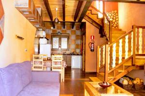 a living room with a blue couch and a kitchen at K2 Jabata Spa Bienestar in Cabezas Altas +26 photos