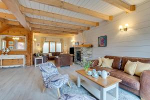 a living room with a couch and a table at Honeywood in Little Petherick