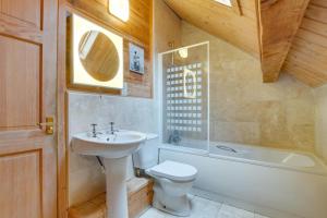 a bathroom with a sink and a toilet and a tub at Honeywood in Little Petherick +15 photos