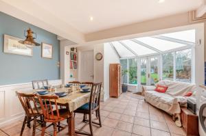 a living room with a table and chairs and a couch at Malt Shovel House in Sandwich