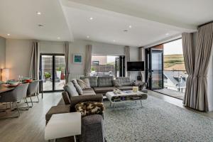 a living room with a couch and a table at Shore End - W1 in Woolacombe