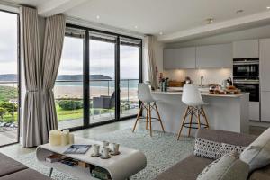 a kitchen and living room with a view of the ocean at Shore End - W1 in Woolacombe