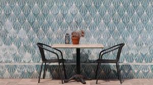 a table and two chairs in front of a wall at Casa Bruna Luxury Lofts in Tampico