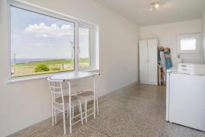 a kitchen with a table and a window at Heavenly View in Southerndown +20 photos